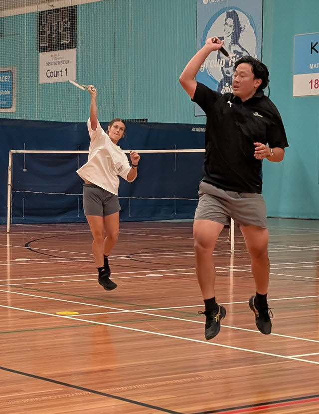 High-Performance Badminton coach with an Eagles AFLW player practicing an overhead slam.